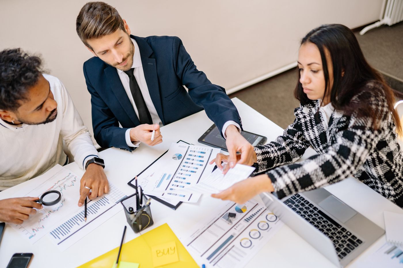 Healthcare finance professionals reviewing dispute resolution paperwork in a meeting